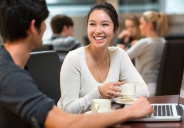 Students chatting in college cafe