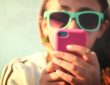 Young girl texting at the beach